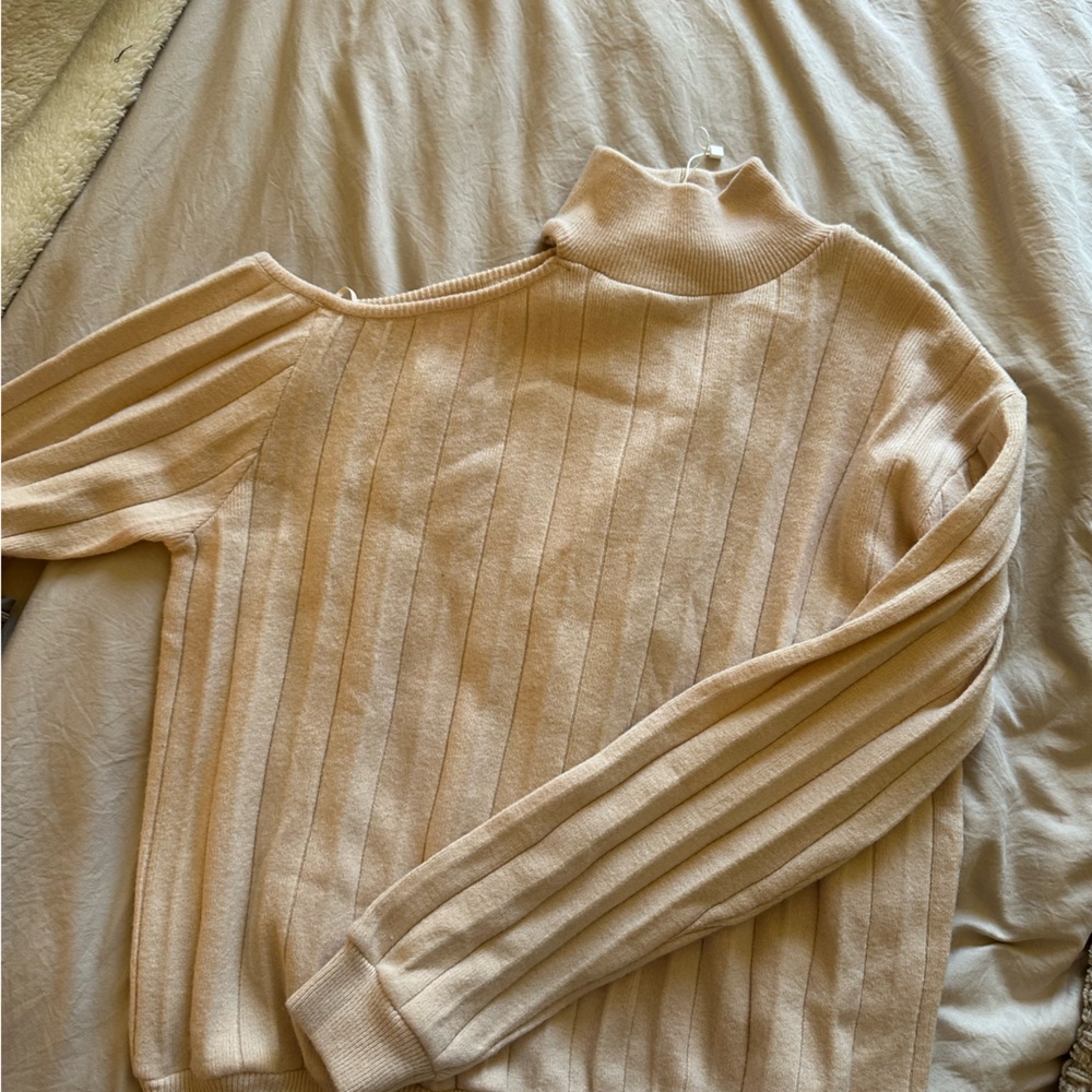 Sweater with shoulder cutout